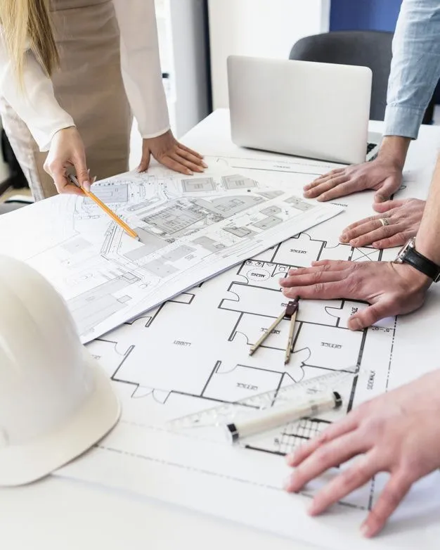 Architect and clients reviewing a custom home pre-design package and site plan in Georgia.